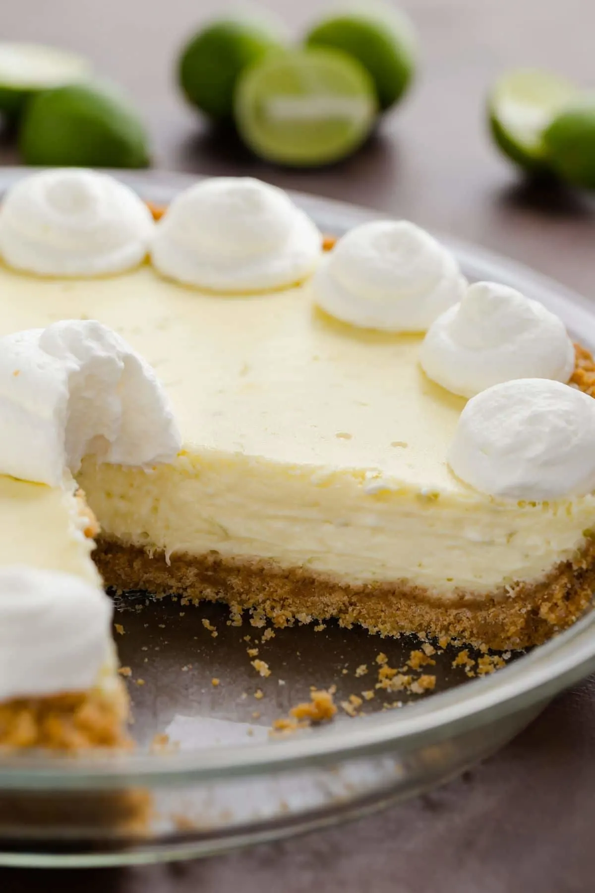 Side view of key lime cheesecake pie with a slice taken out.