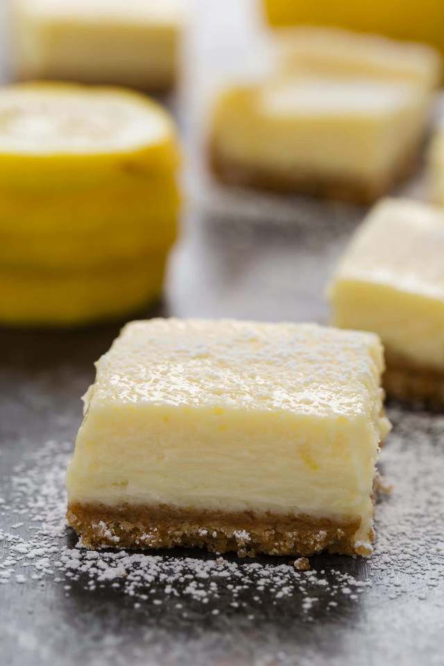 Easy lemon cheesecake bars dusted with powdered sugar.
