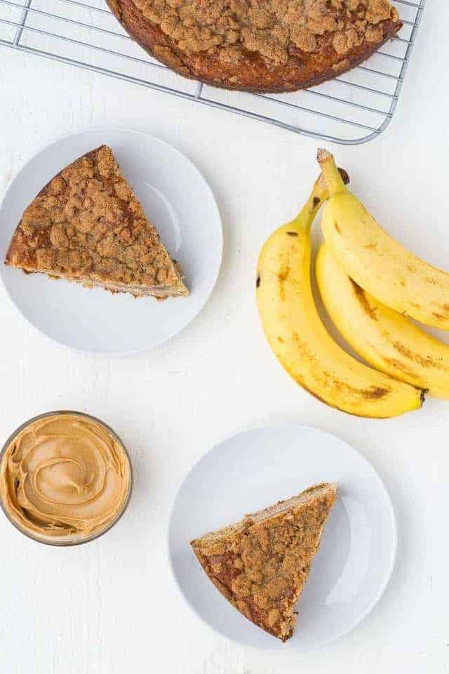 overhead view of peanut butter and banana coffee cake slices on white plates