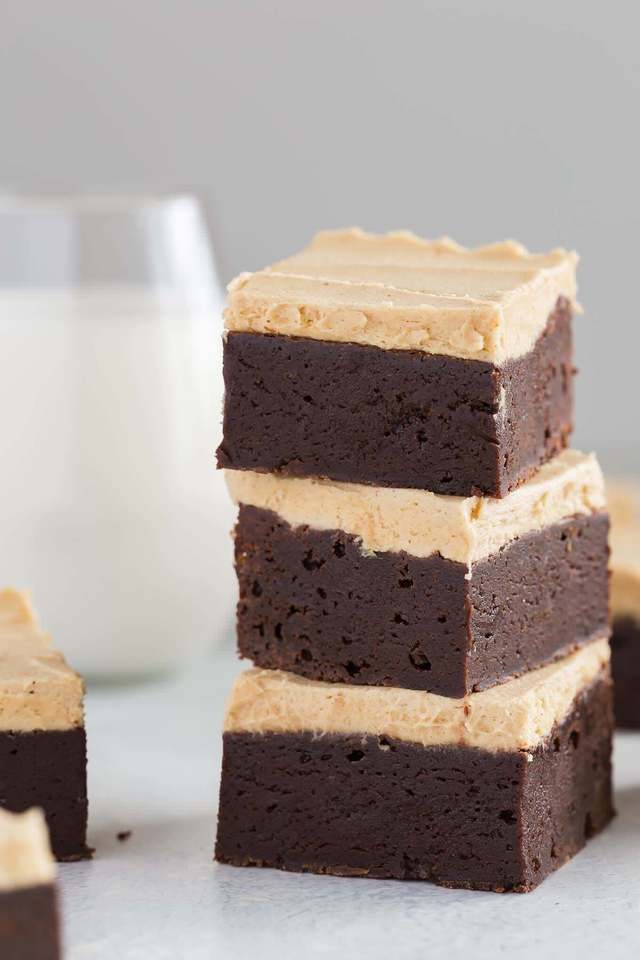 a stack of three fudgy brownies with peanut butter frosting 