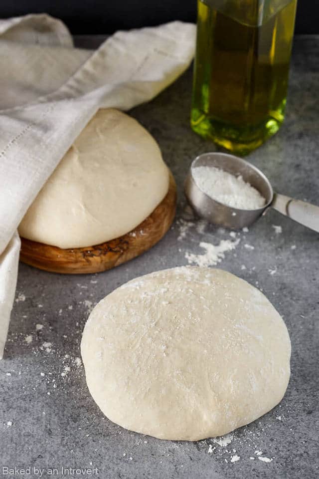 homemade pizza dough on a gray background