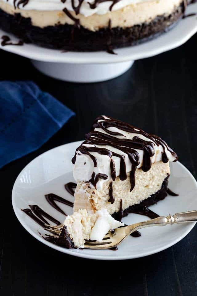 a slice of cappuccino cheesecake with a fork taking a bite out