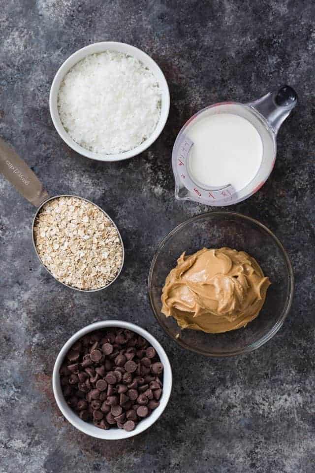 All the ingredients for chocolate peanut butter balls with coconut set on a counter top.