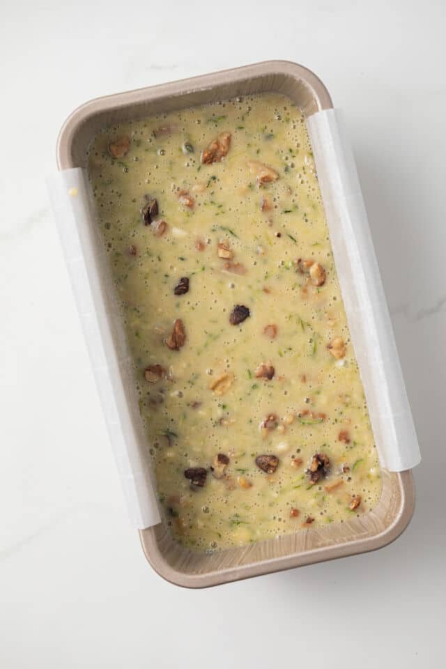 Unbaked honey nut zucchini bread batter in loaf pan.