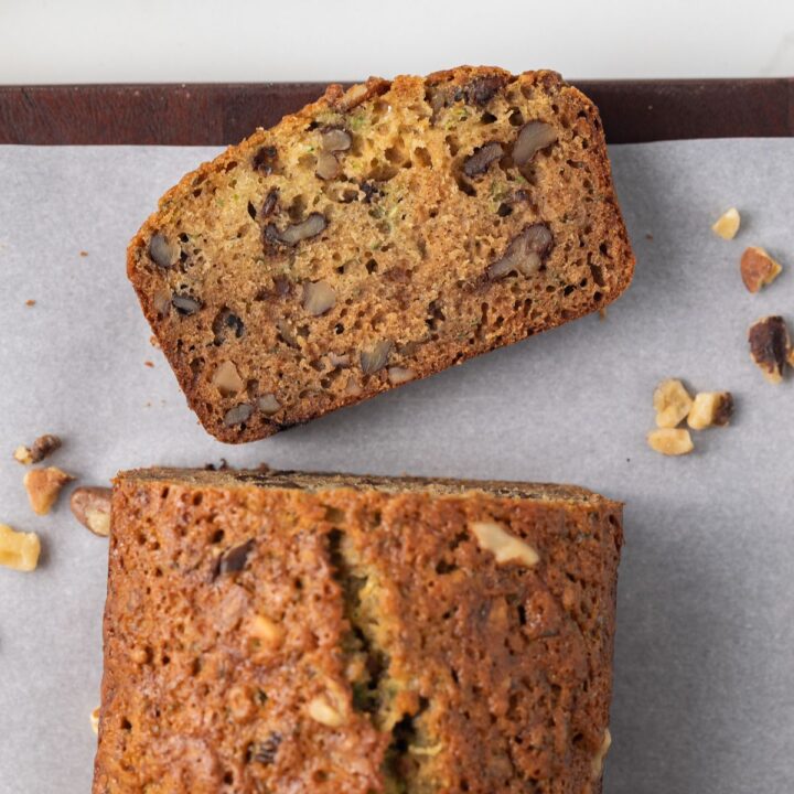Overhead view of honey nut zucchini bread with slice taken off.