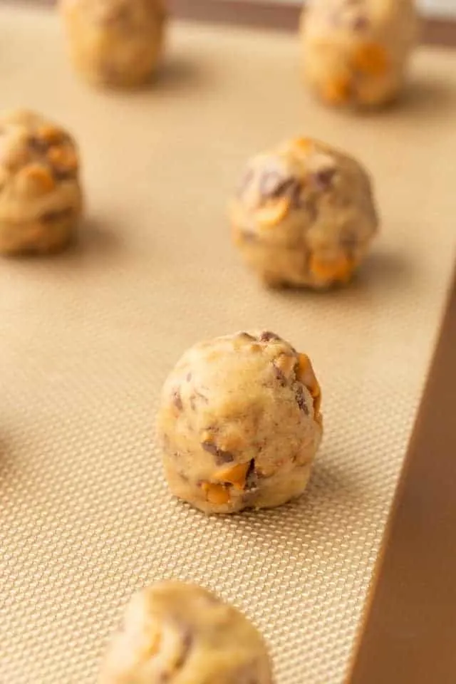 butterscotch toffee cookie dough balls on a baking sheet