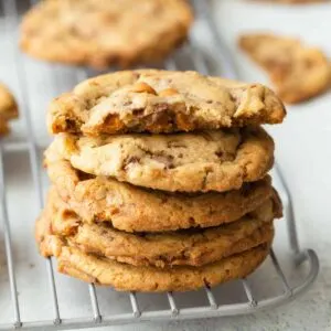 butterscotch toffee cookies stacked on a wire rack