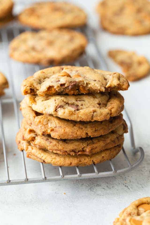 butterscotch toffee cookies stacked on a wire rack