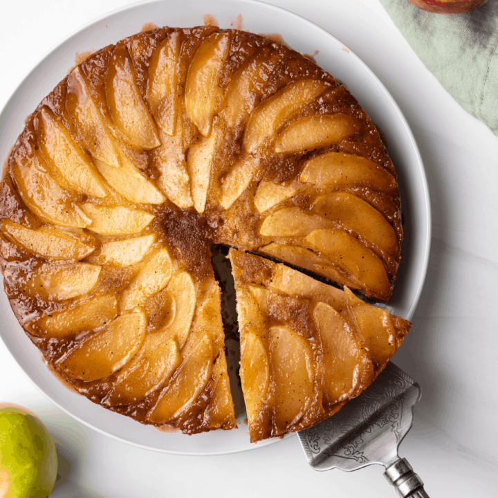 Spiced apple upside down cake with slice being pulled away.