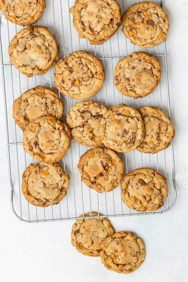 butterscotch toffee cookies spread out on a wire rack