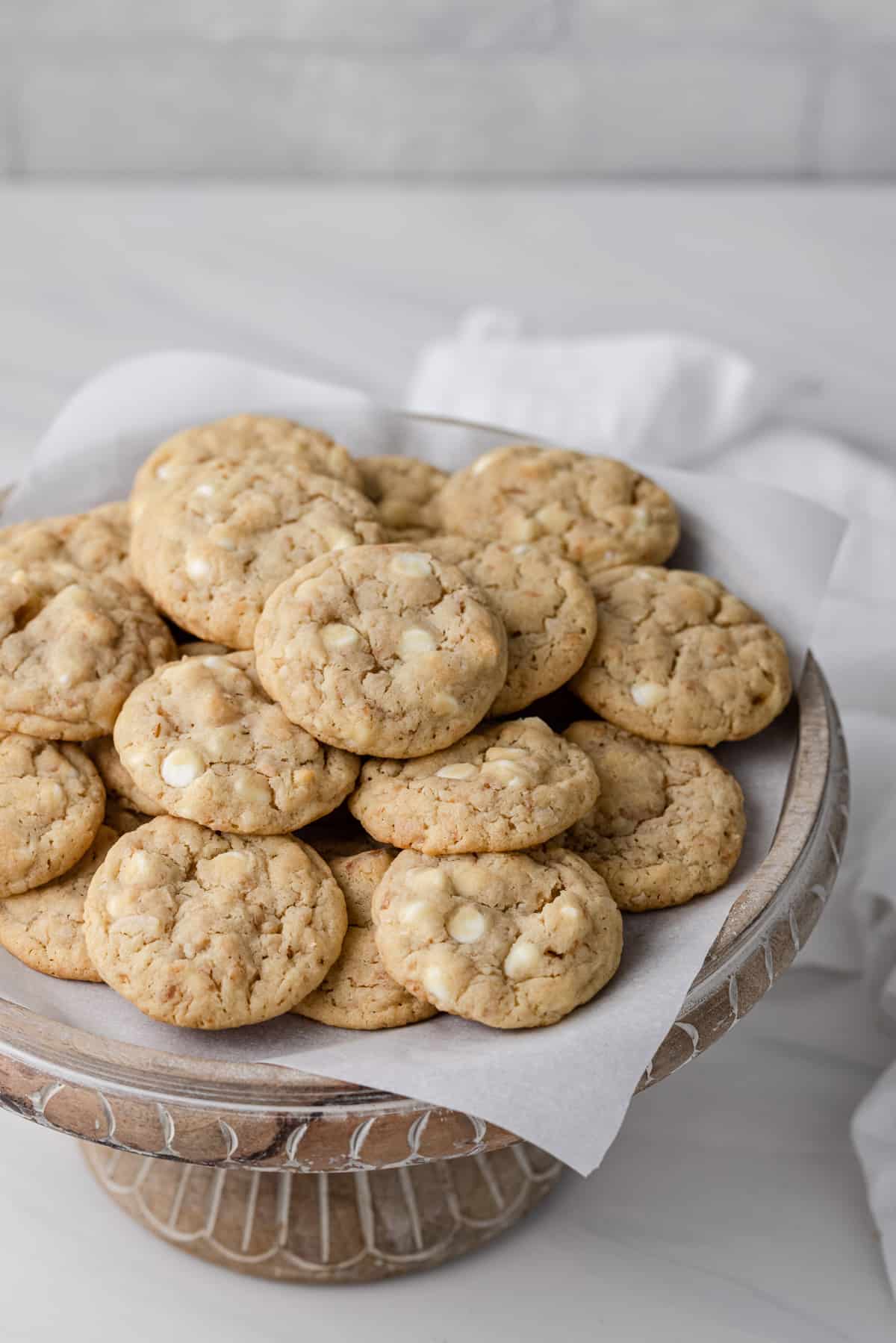 A plate of white chocolate chip cookies with toasted coconut