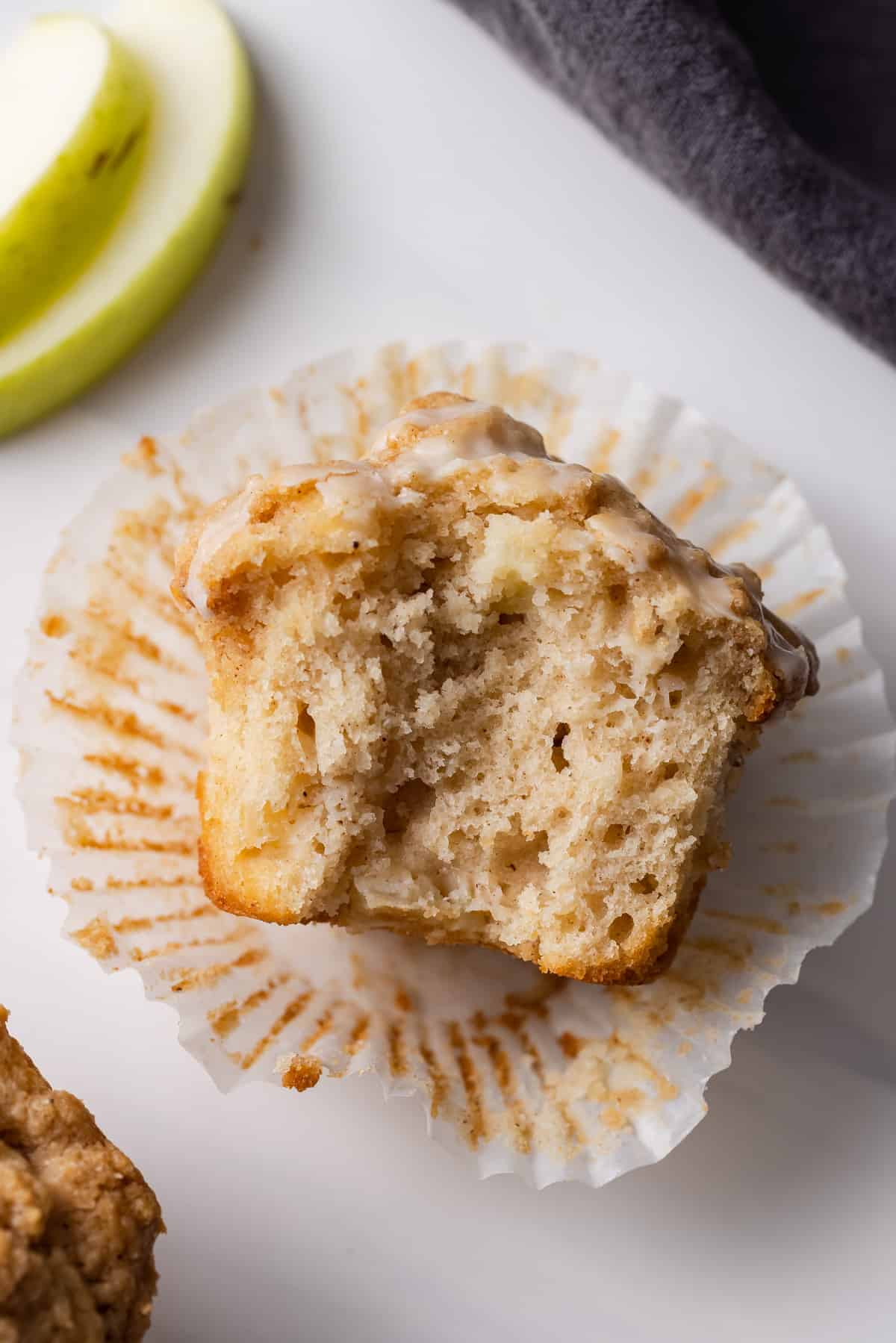 An apple streusel muffin with a bite missing