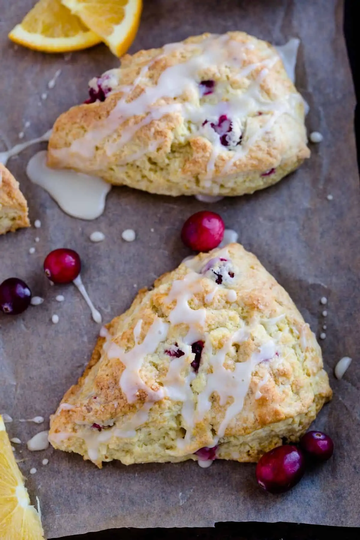 Glazed Cranberry Orange Scones on brown paper