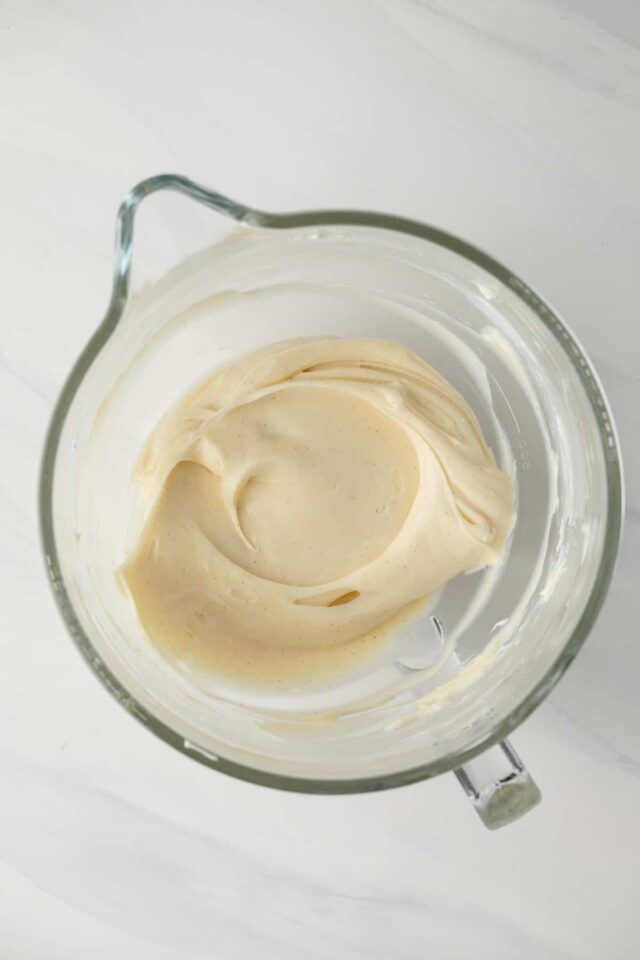 Whipped mascarpone cream cheese frosting in a mixing bowl
