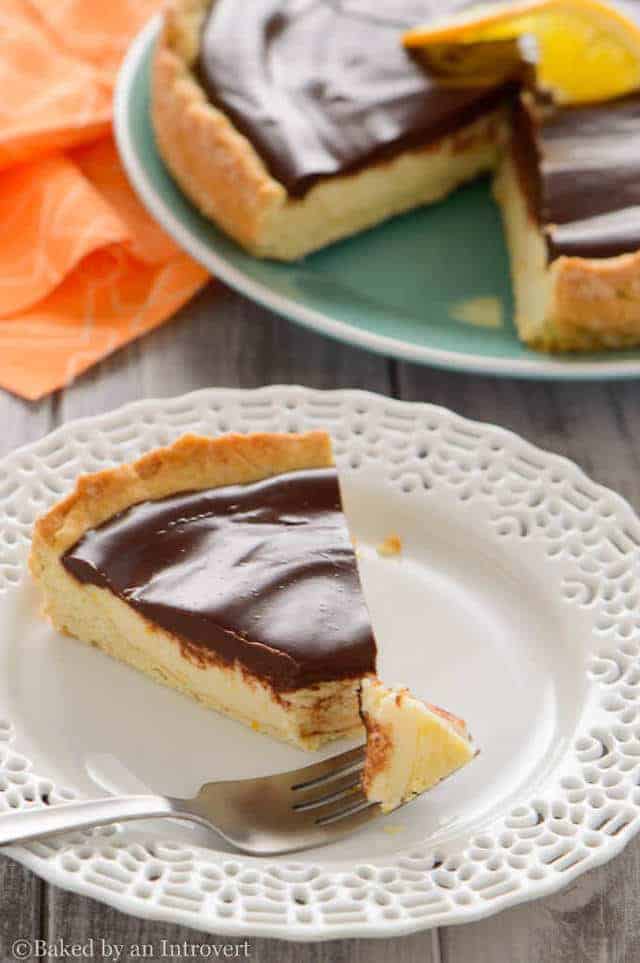 a slice of Chocolate Orange Ricotta Tart with a fork taking a bite out