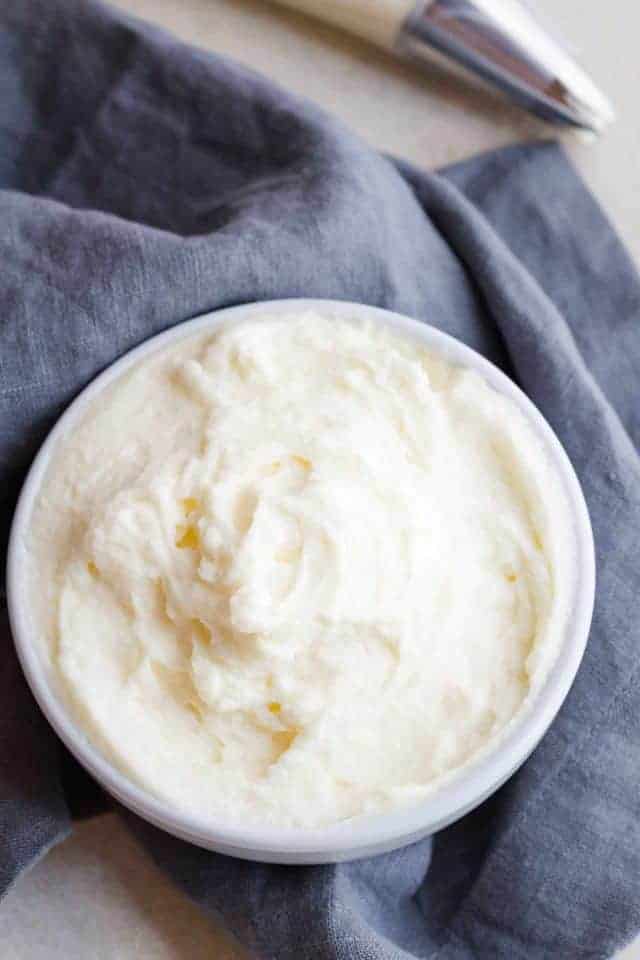 Eggnog whipped cream topping in a white bowl.