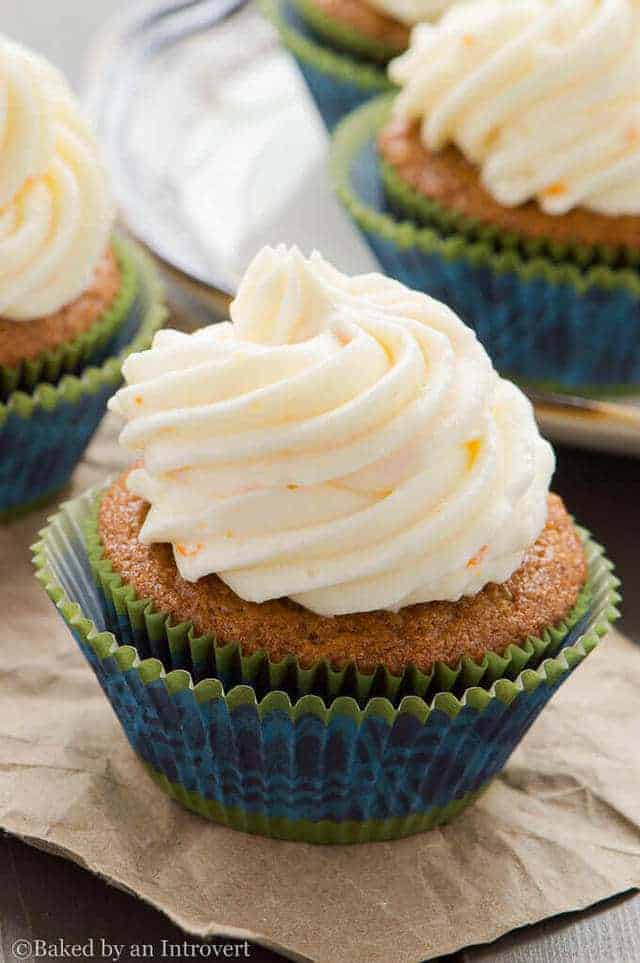 side view of a Gingerbread Cupcake with Orange Mascarpone Frosting on brown paper