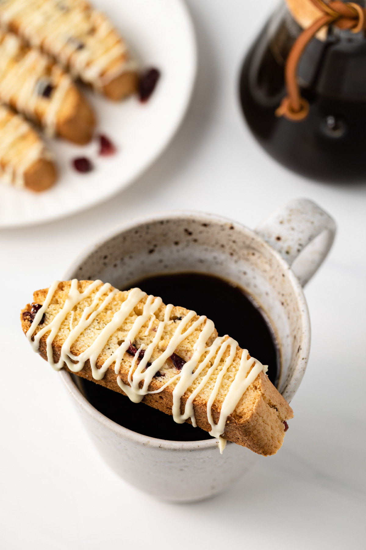 Overhead view of a orange cranberry biscotti over a cup of coffee