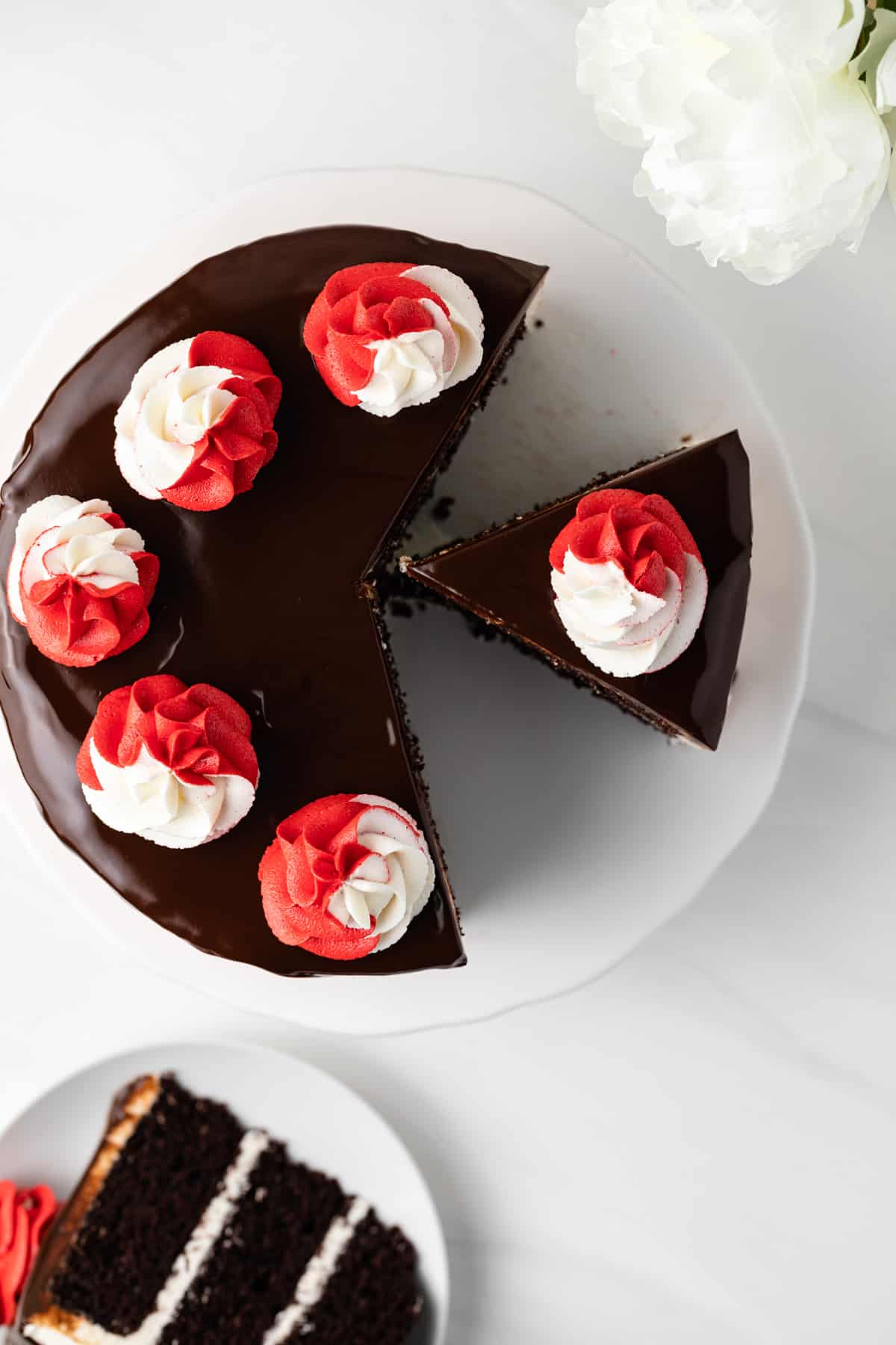 Overhead view of a peppermint fudge cake with two slices cut