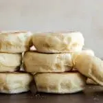 English muffins stacked on brown background