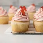 Vanilla yogurt cupcakes on wire rack.