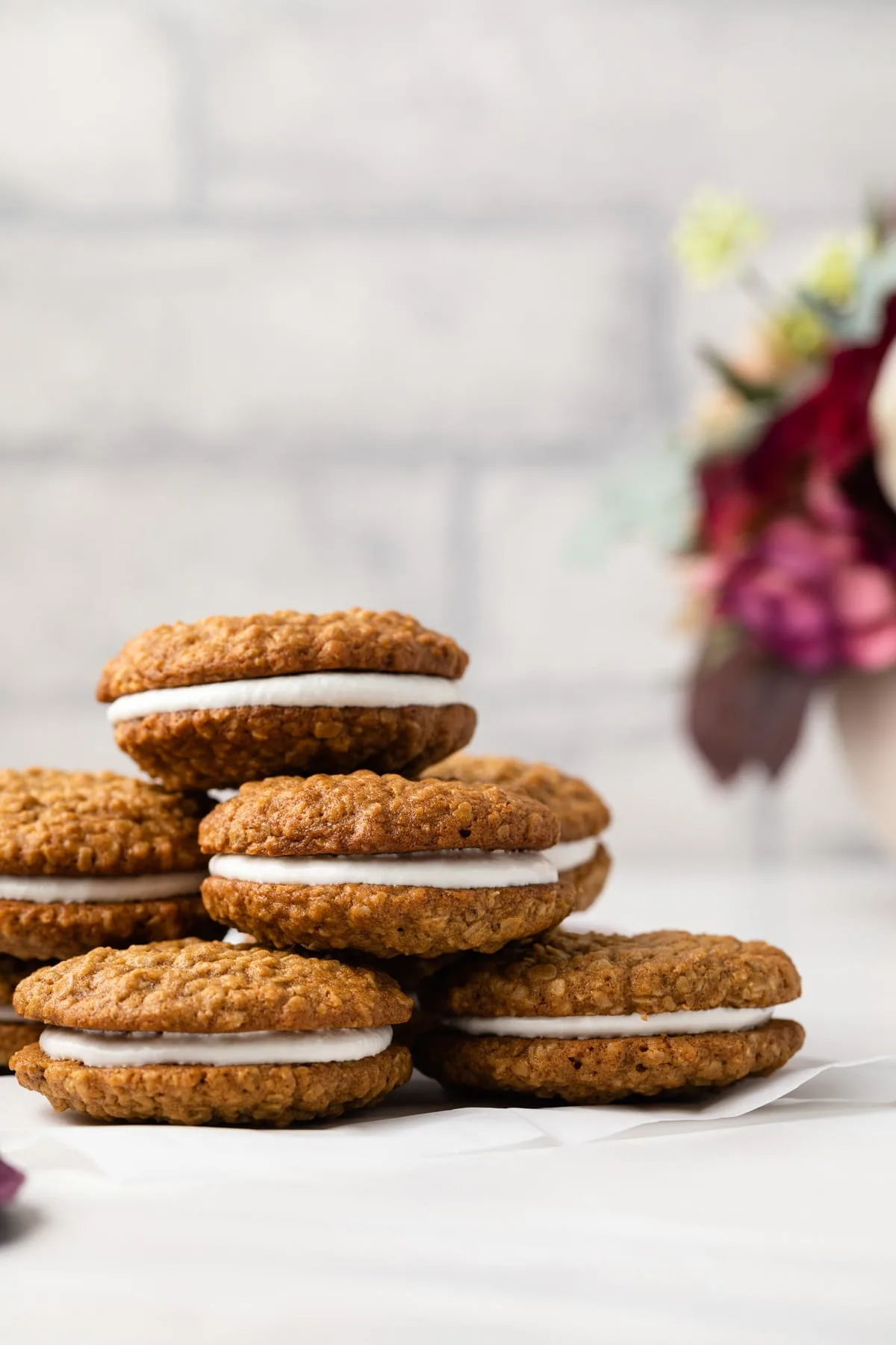 Oatmeal cream pie cookies on a wire rack.