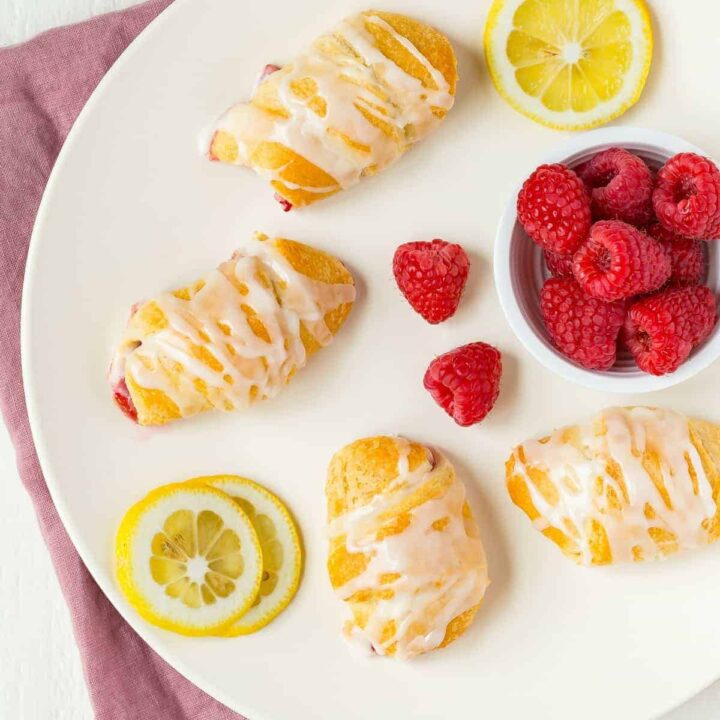 overhead view of raspberry lemon crescent rolls on a white plate