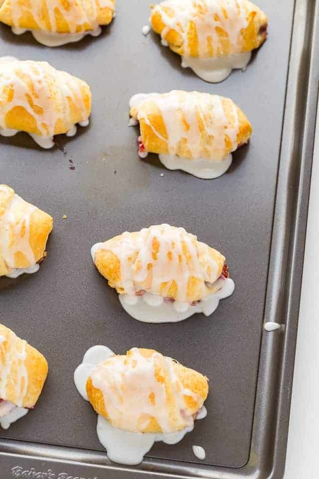 overhead view of raspberry lemon crescent rolls on a baking sheet