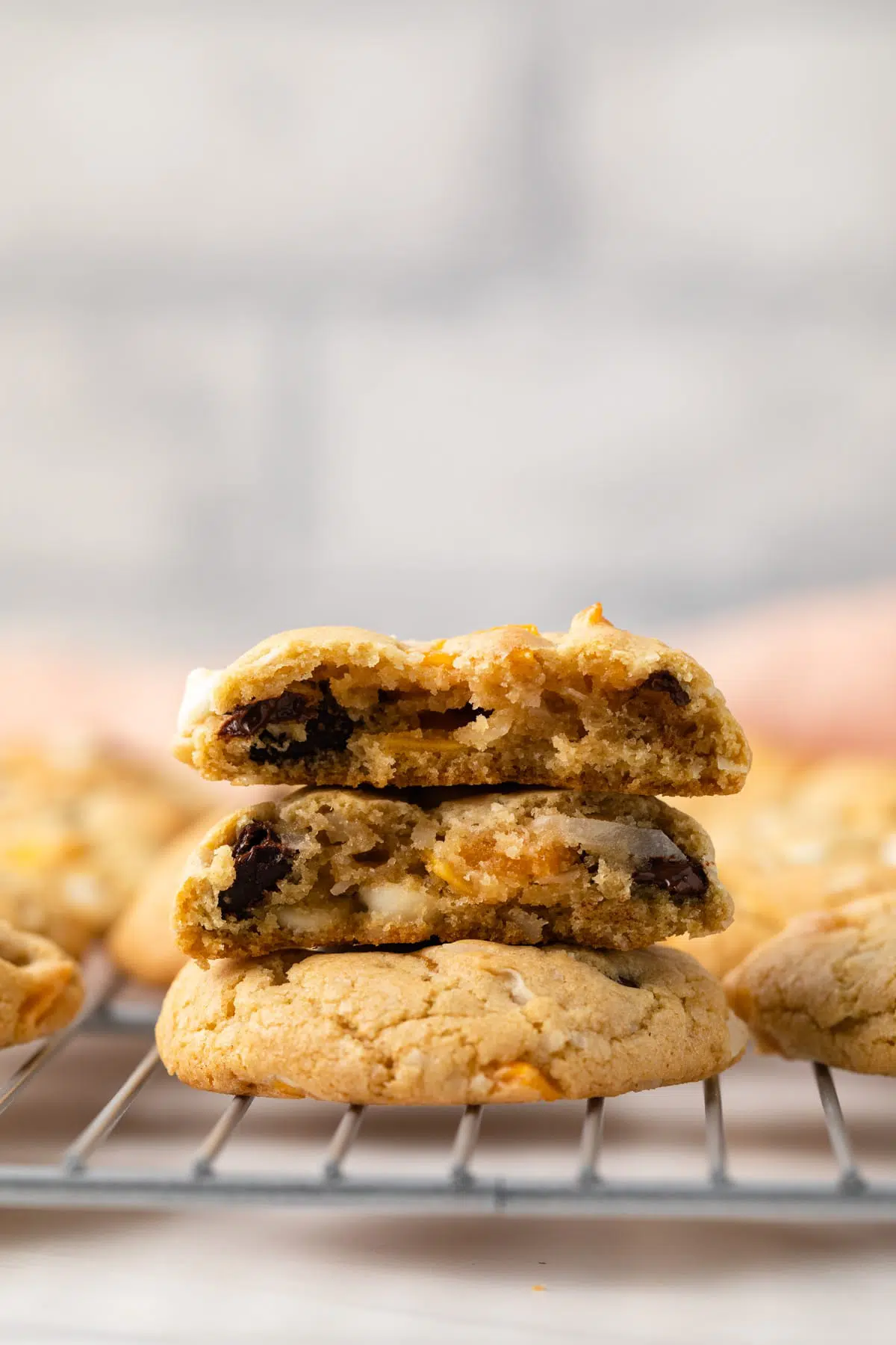 Coconut Mango Chocolate Chip Cookies with one broken in half.