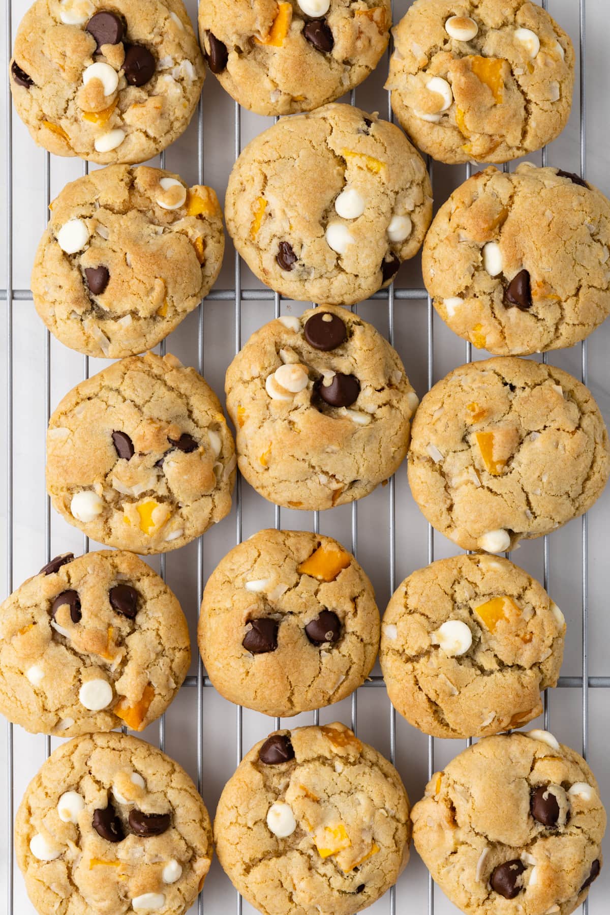 Overhead of Coconut mango chocolate chip cookies on wire rack.