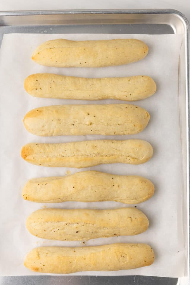 Baked breadsticks on baking sheet.
