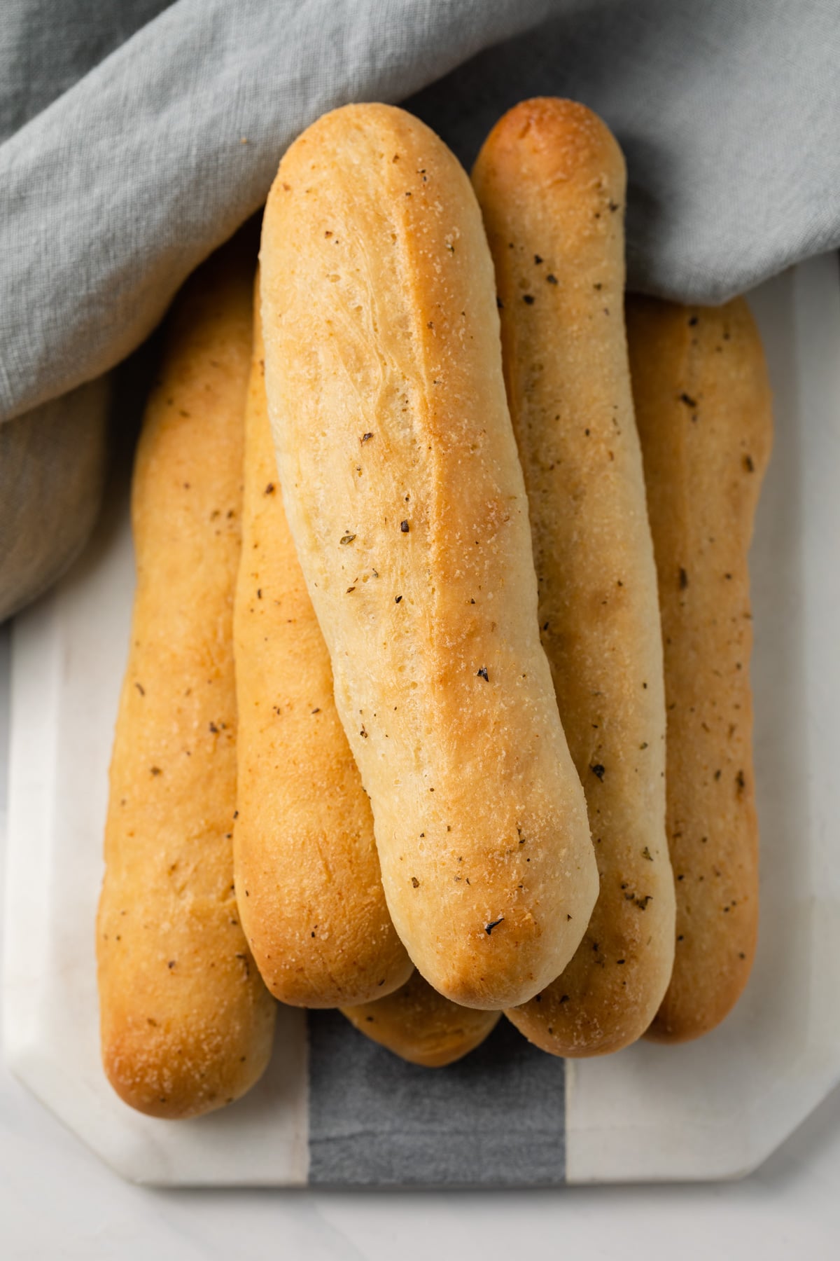 Garlic Breadstick on white and grey serving platter.