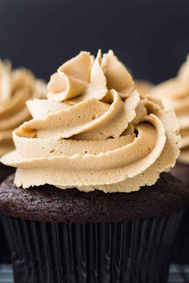 Close-up view of Biscoff Cookie Butter Frosting swirled on top of a chocolate cupcake.