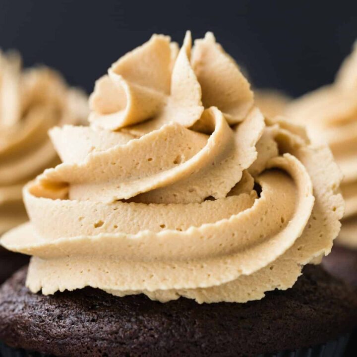 Close-up view of Biscoff Cookie Butter Frosting swirled on top of a chocolate cupcake.