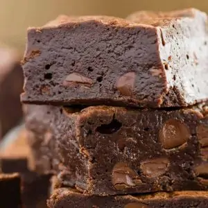 Three double chocolate brownies stacked on top of one another.