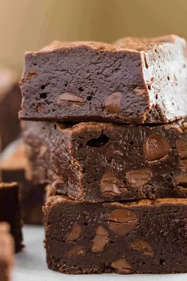 Three double chocolate brownies stacked on top of one another.