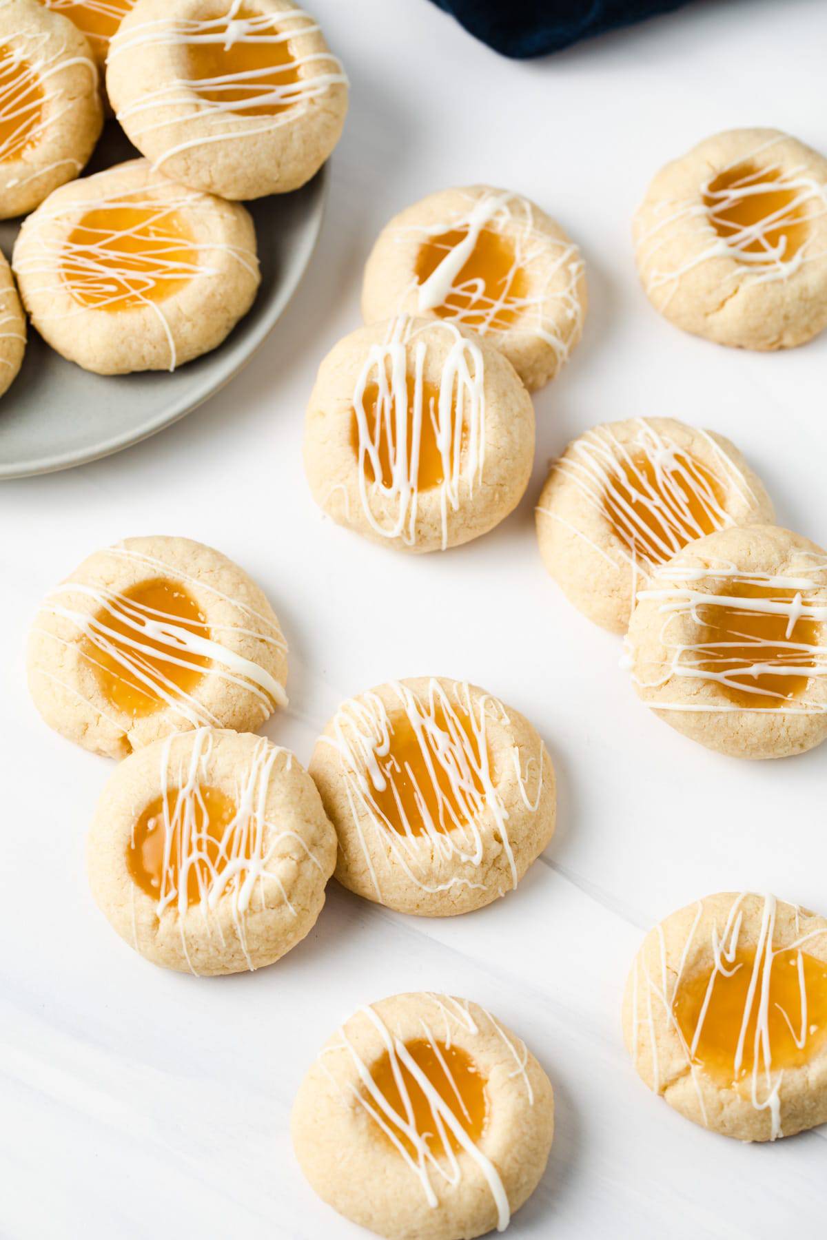 lemon thumbprint cookies with lemon curd on white background