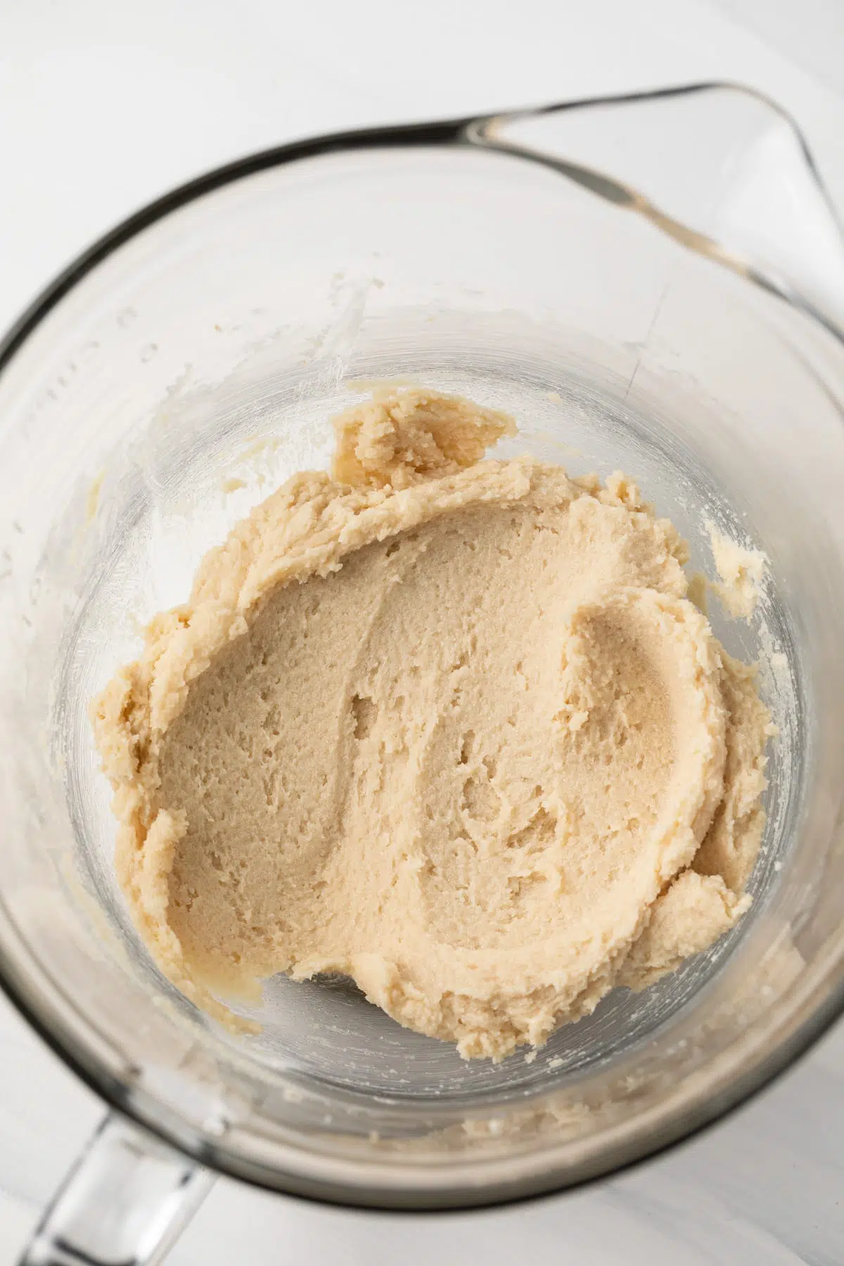 Creamed butter and sugar in a glass bowl.