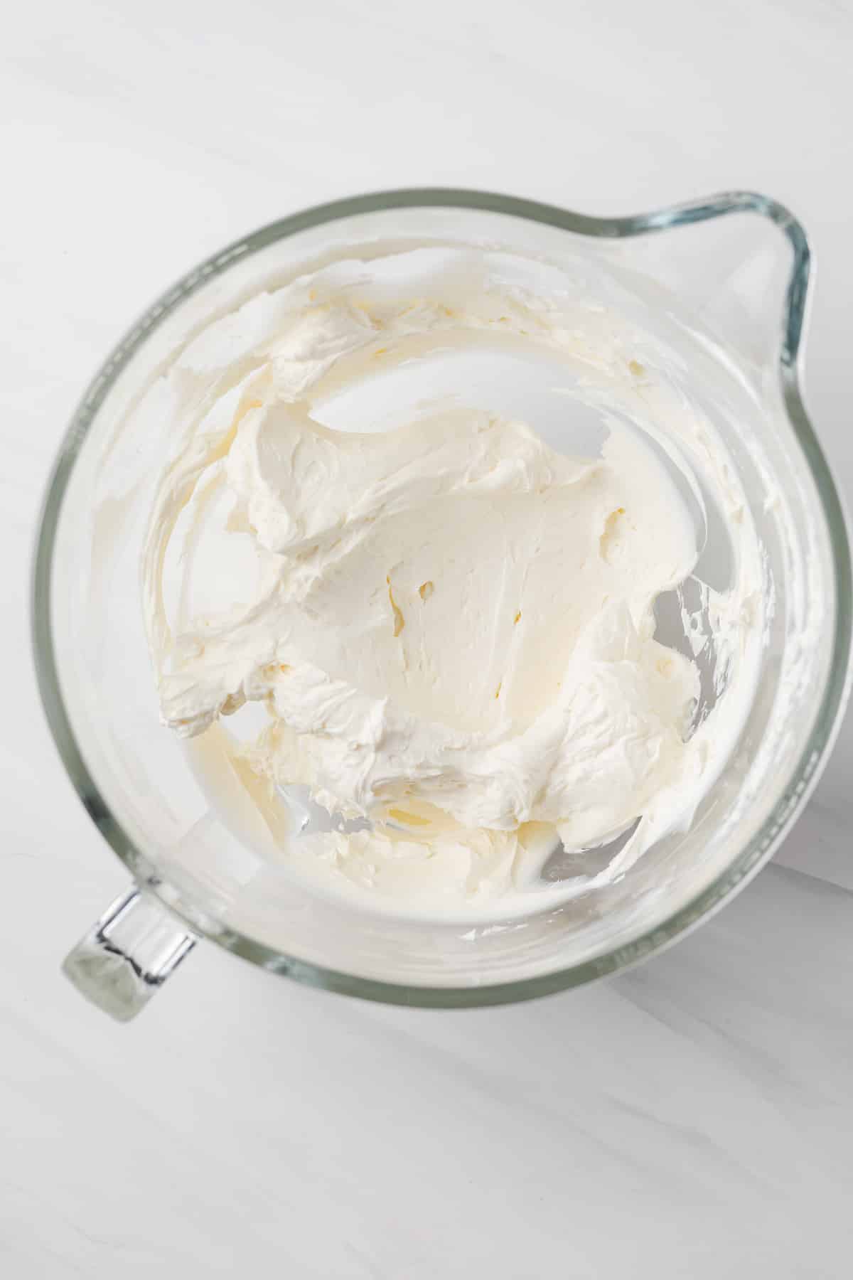 Cream cheese whipped in glass bowl.