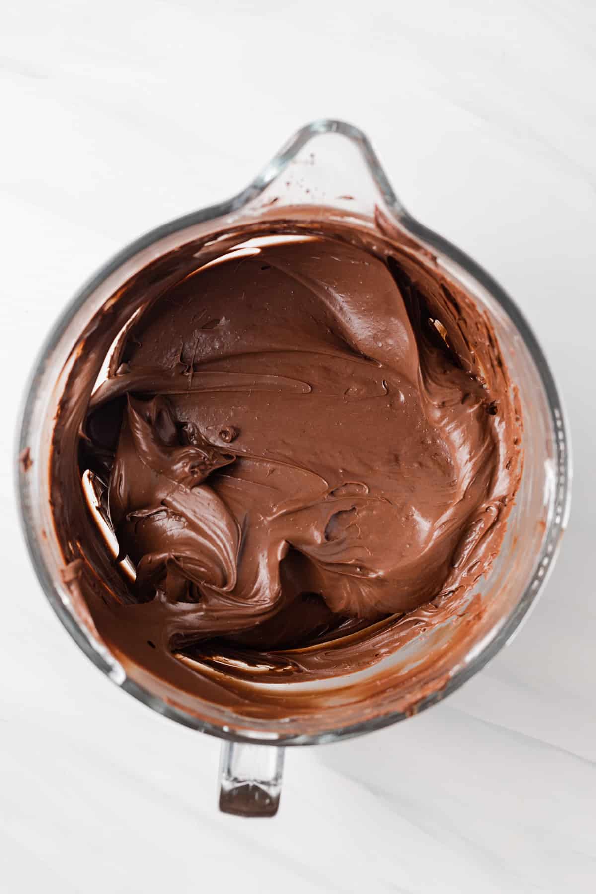 Chocolate cheesecake batter in glass bowl.