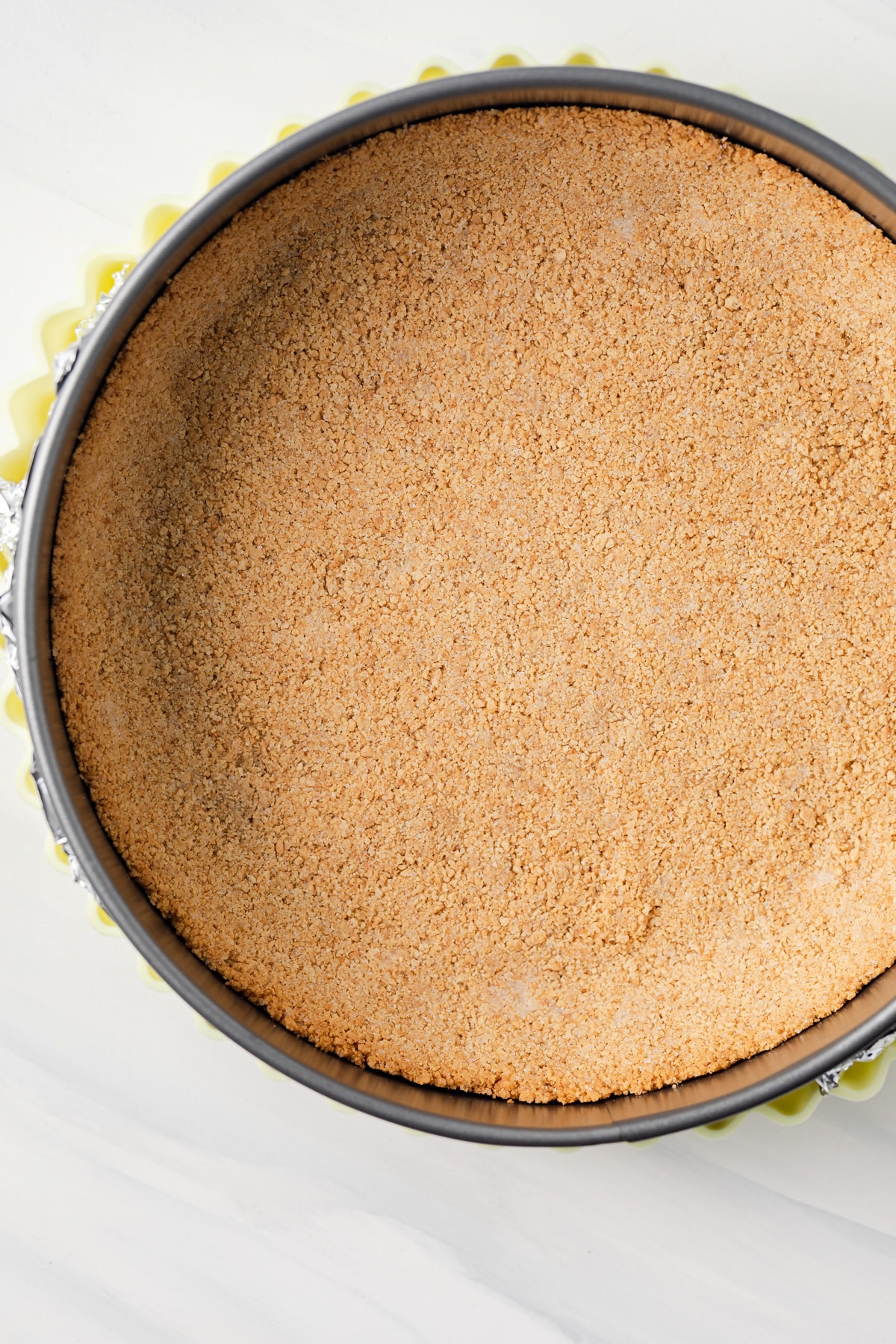 Graham cracker crust in baking pan.