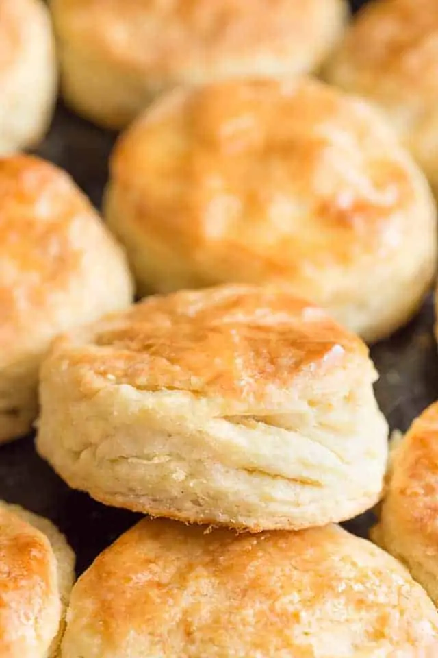Close up view of the flaky layers of a honey cream cheese biscuit.