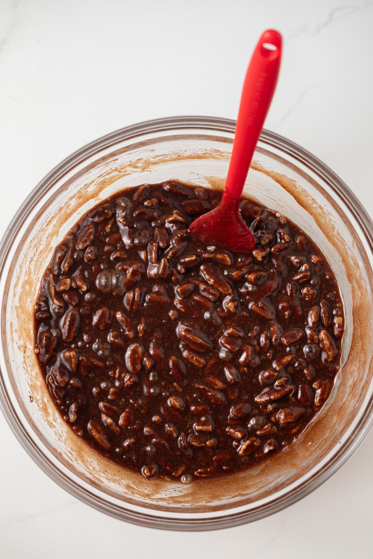 Chocolate bourbon pecan filling in glass bowl.