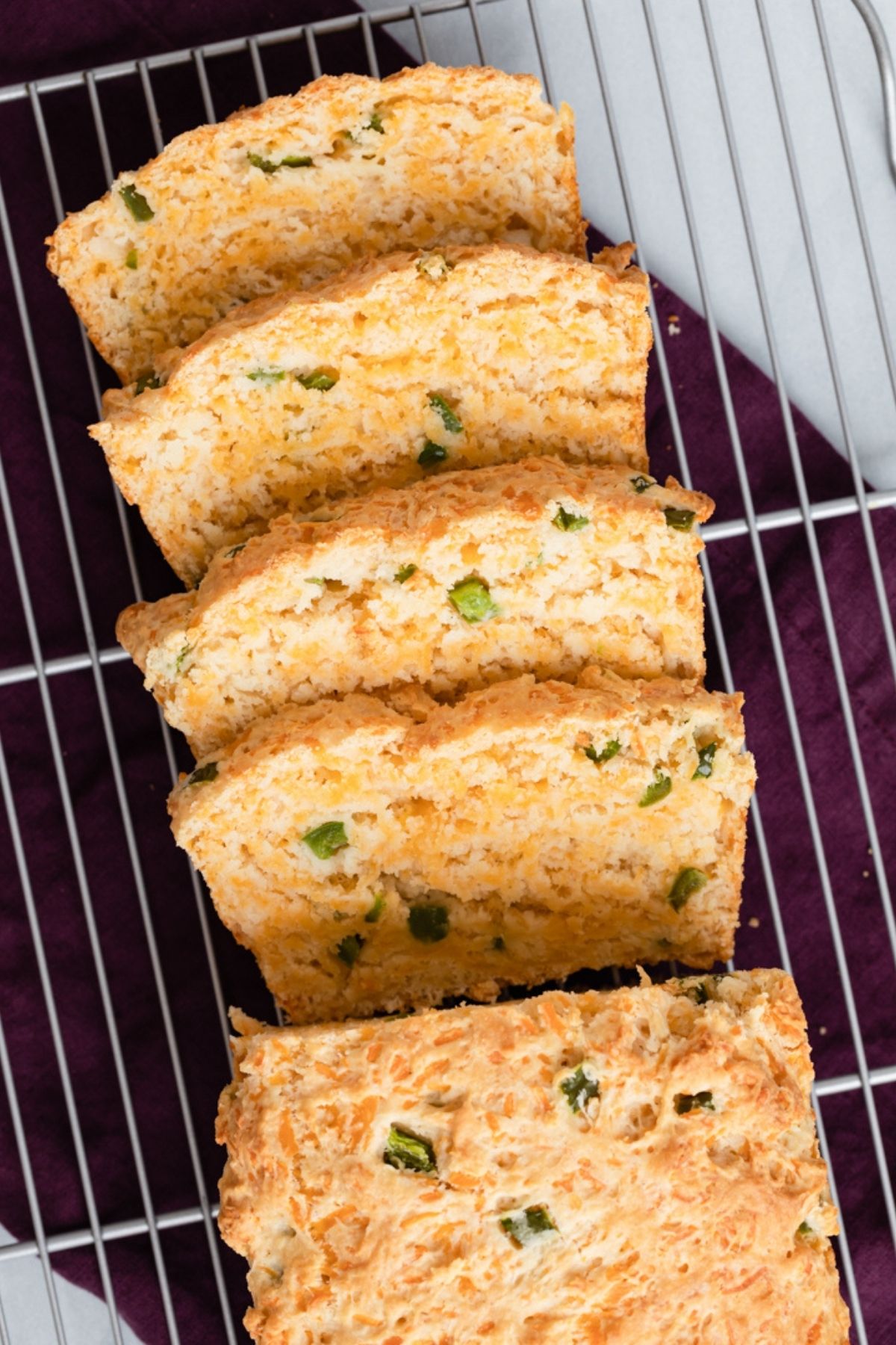 sliced buttermilk bread with cheddar and jalapenos on a wire rack