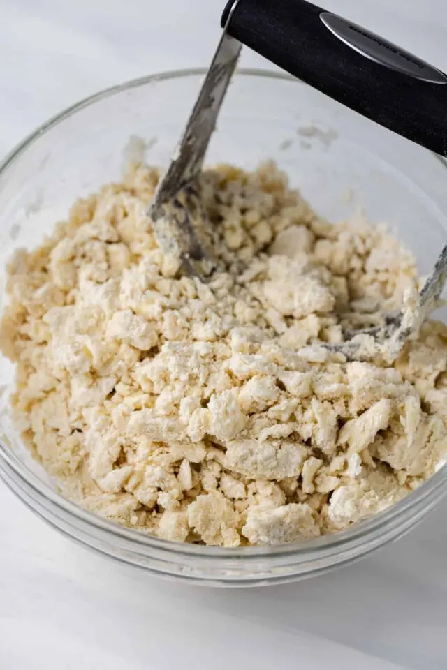 Butter being cut into pastry dough