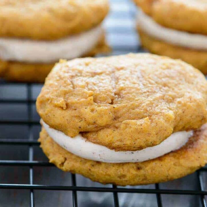 side view of pumpkin whoopie pies on a wire rack