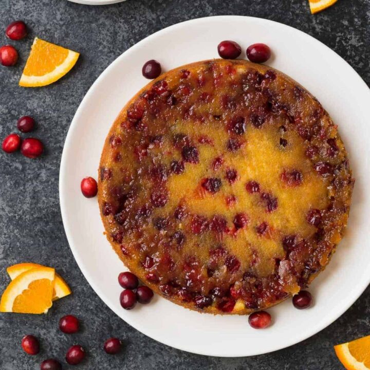 Inverted Cranberry Orange Upside Down Cake on a serving plate.
