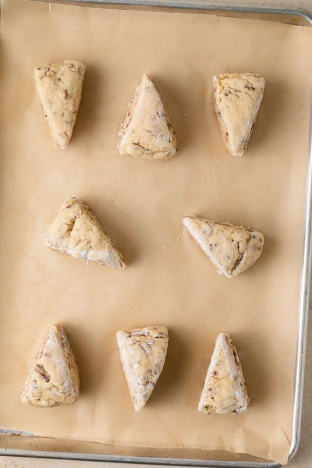 Unbaked maple scones on parchment paper