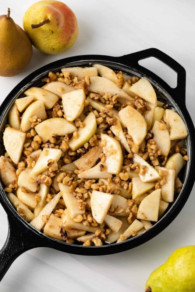 Pear walnut crisp filling in a cast iron skillet