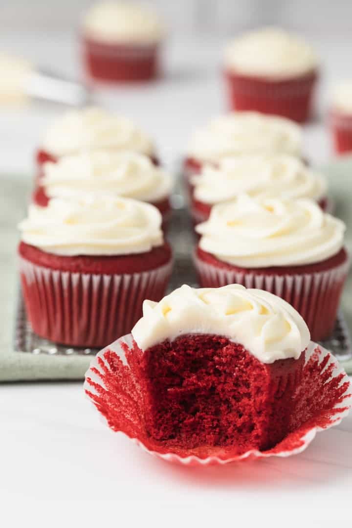 red velvet cupcake with a bite taken out so the fluffy inside is visible